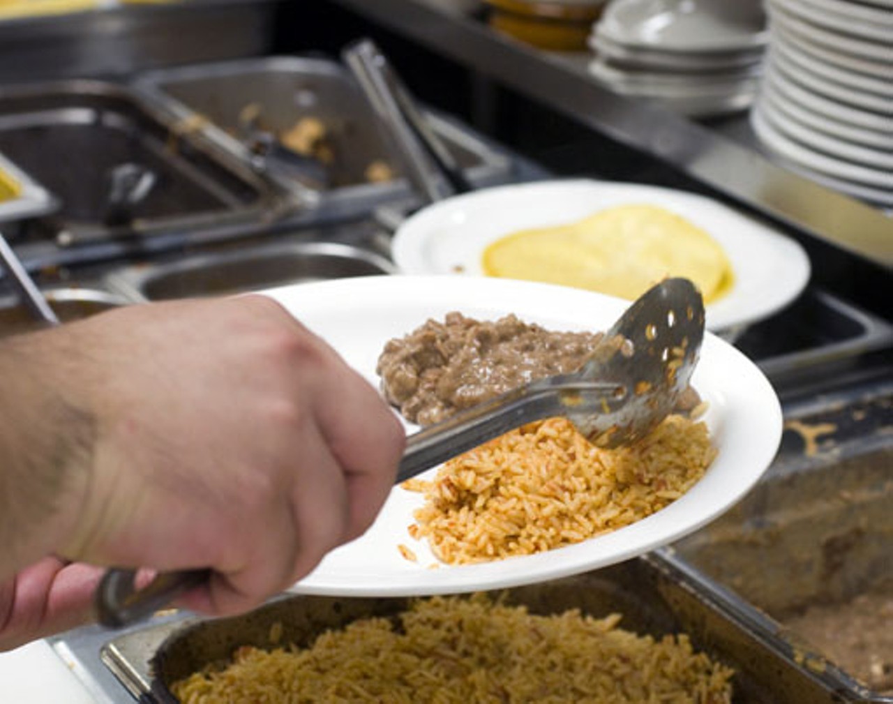 Preparing the plate with rice and beans.