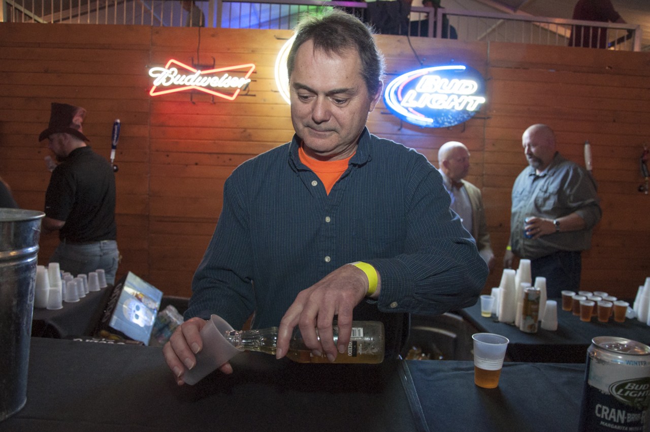 Chuck Rebeck pouring an Oculto beer - brewed with blue agave and blended with beer-aged in tequila barrels.