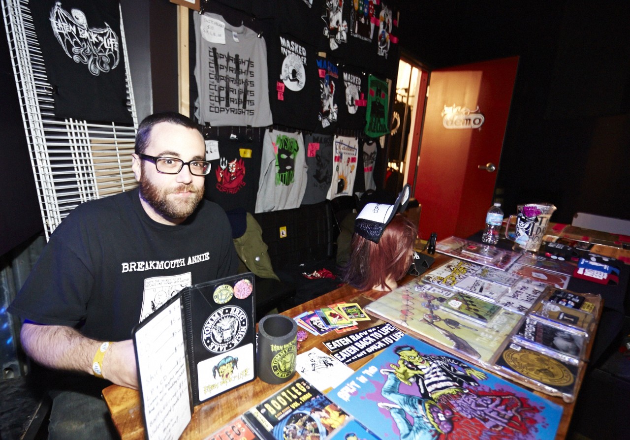 Daren Gratton holds down the merch table at the show.