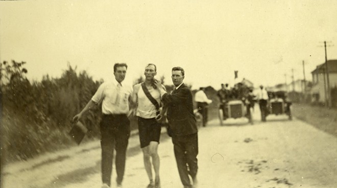 Thomas Hicks, one of the athletes in the 1904 Olympics, being supported by his trainers in the 24-mile marathon race.