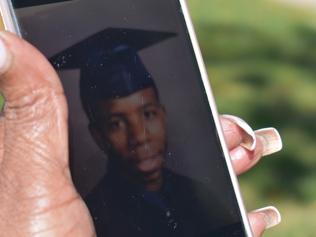 Mary James holds a photo of her son LeVaughn from his graduation day.