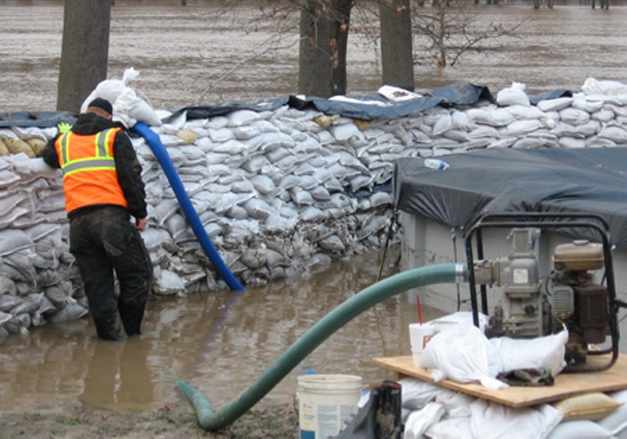 The sand bags are not enough to keep the water at bay; a pump is needed to get out the water that seeps through the bags.