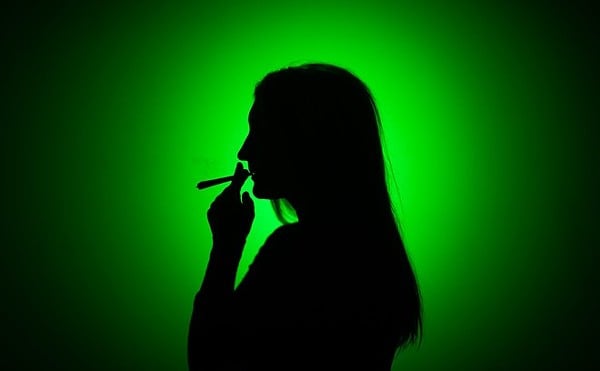 Image of woman smoking reefer.