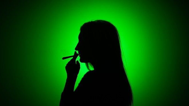 Image of woman smoking reefer.
