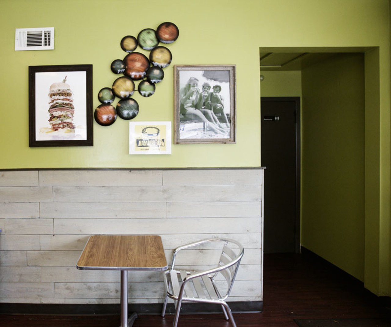 The lime green, cedar walls and whimsical decor add a great deal of charm to this small space.