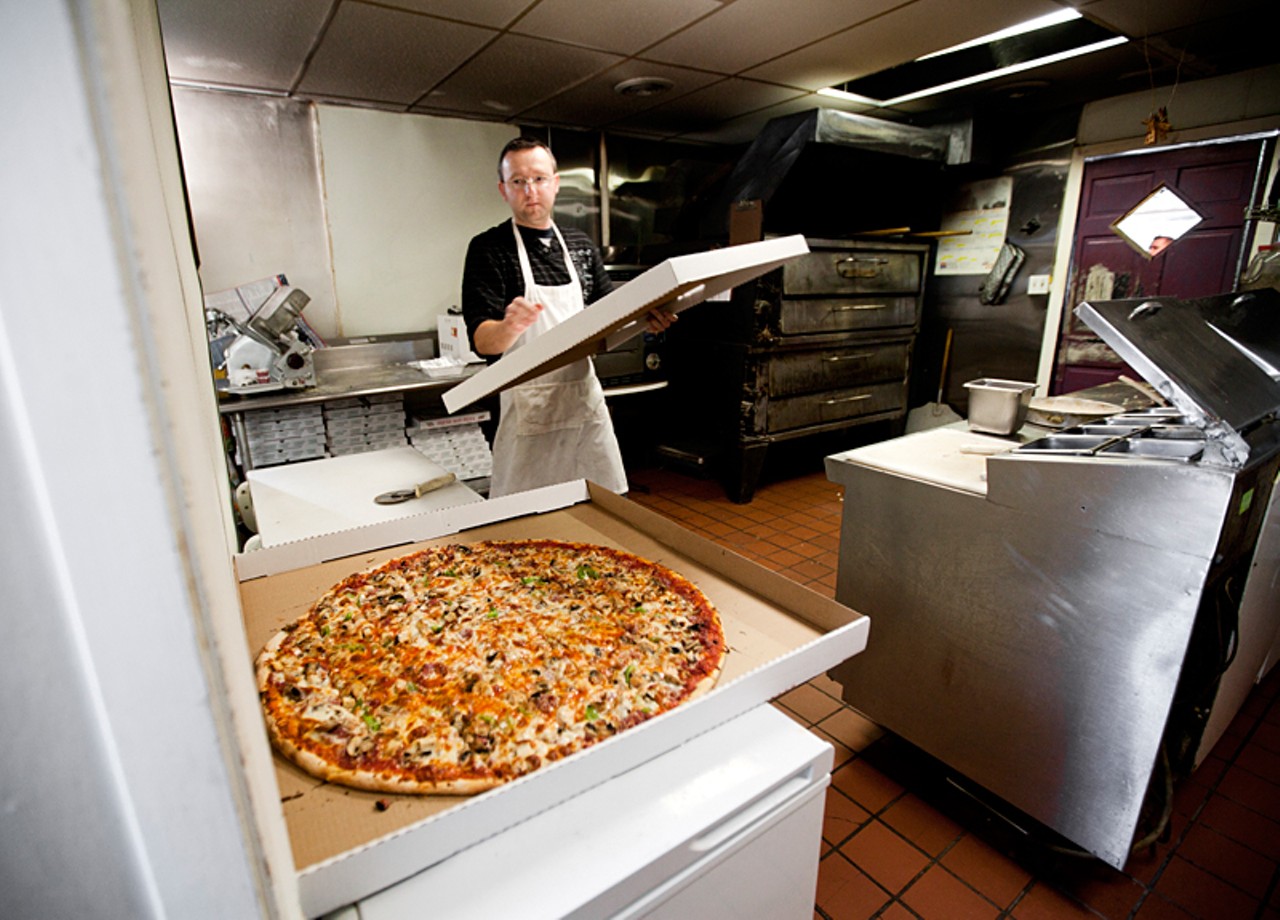 Sabro Islamovic brings over the lid for the 30" pizza, known as "the big one" at Mr. X's Pizza.