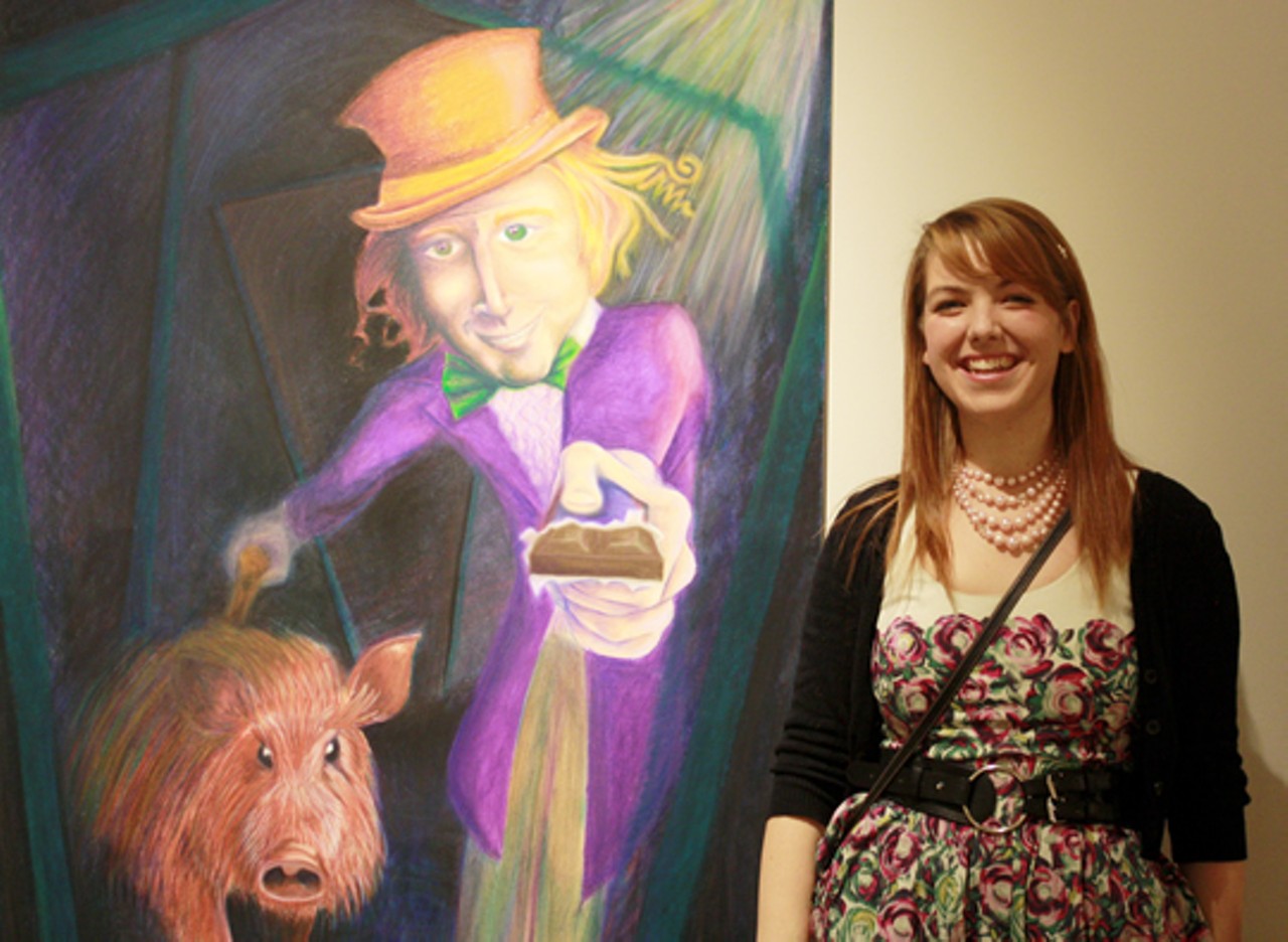 Kelly Eggers with her work in oil pastels.