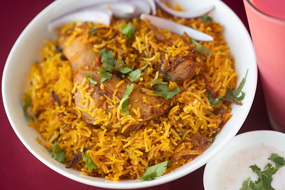 Chicken biryani with basmati rice and spices.
