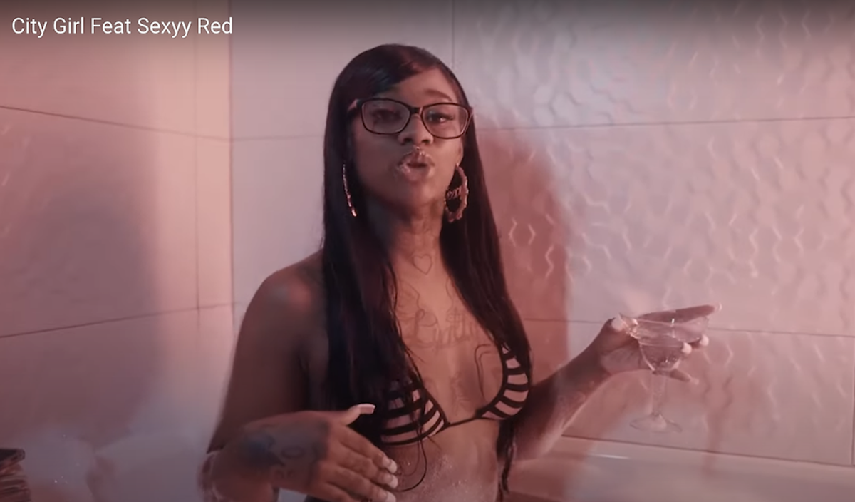 Sexyy Red enjoys a bath with a bikini and a martini.