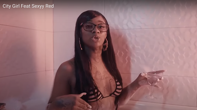 Sexyy Red enjoys a bath with a bikini and a martini.