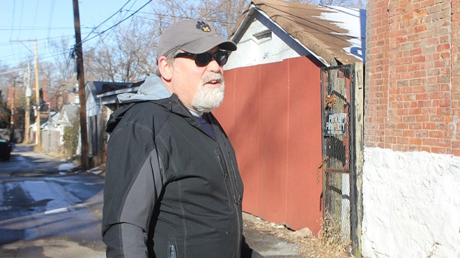Tower Grove East resident Joseph Goodman in the alley between his home and one owned by Dara Daugherty.