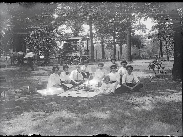 An old photo of picnic-ers in the park.