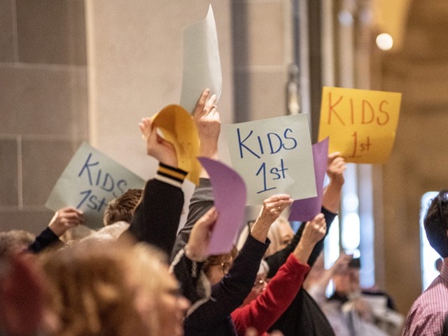 Backers of legislation to ban gender-affirming treatments for minors waved signs that say “Kids 1st” during a March rally in the Missouri Capitol.
