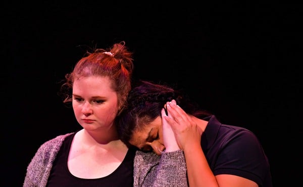 Christina Rios, as Dorothy, leans her head on the shoulder of Rhiannon Creighton, playing Rosalind.