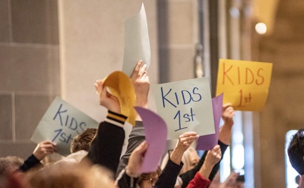 Backers of legislation to ban gender-affirming treatments for minors waved signs that say “Kids 1st” during a March rally in the Missouri Capitol.