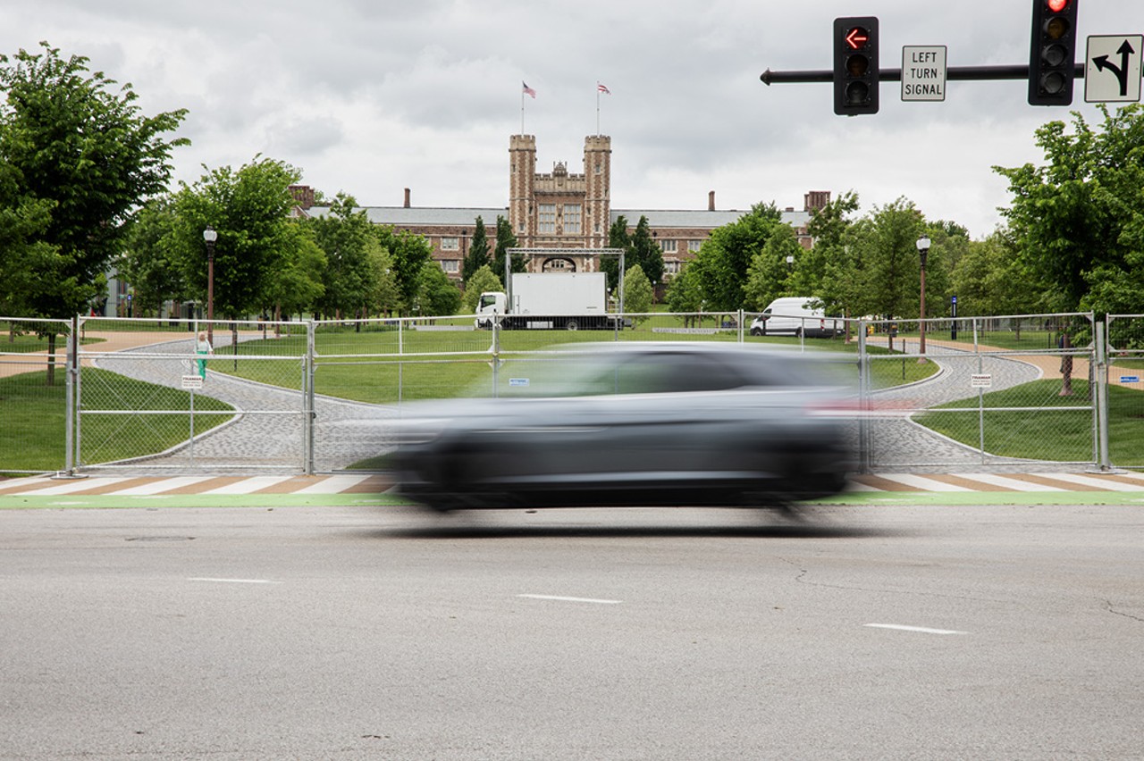 A car drives past the metal fence surrounding Wash U’s Danforth Campus on Monday, May 6, 2024.
