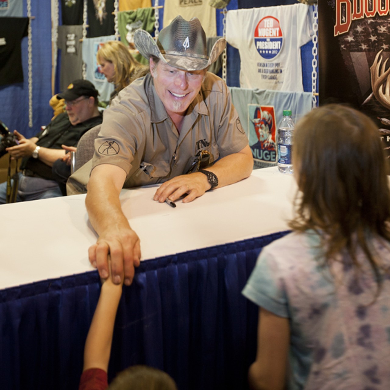 Ted Nugent signing autographs and visiting with fans.