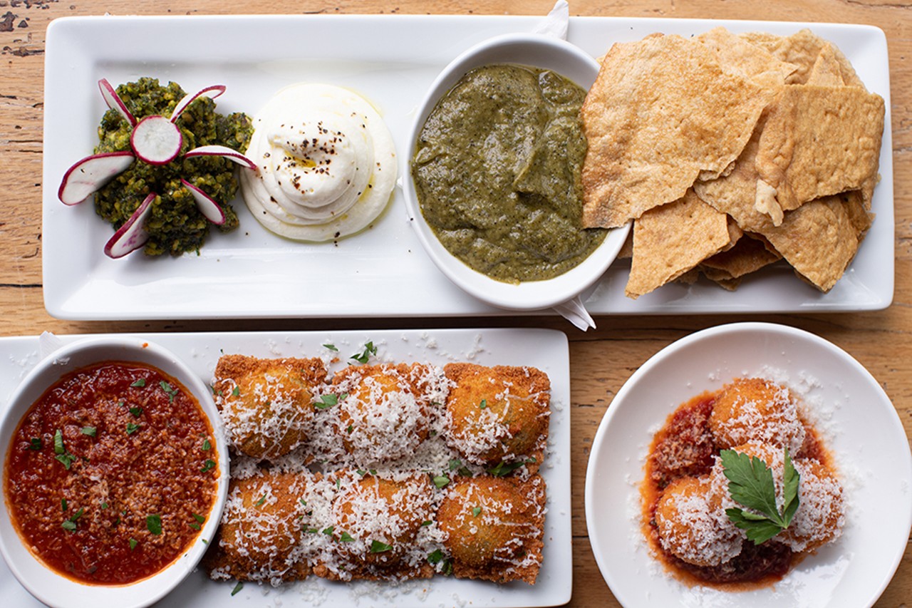 A selection of starters: pistachio pesto and charred zucchini dip, toasted ravioli and arancini.