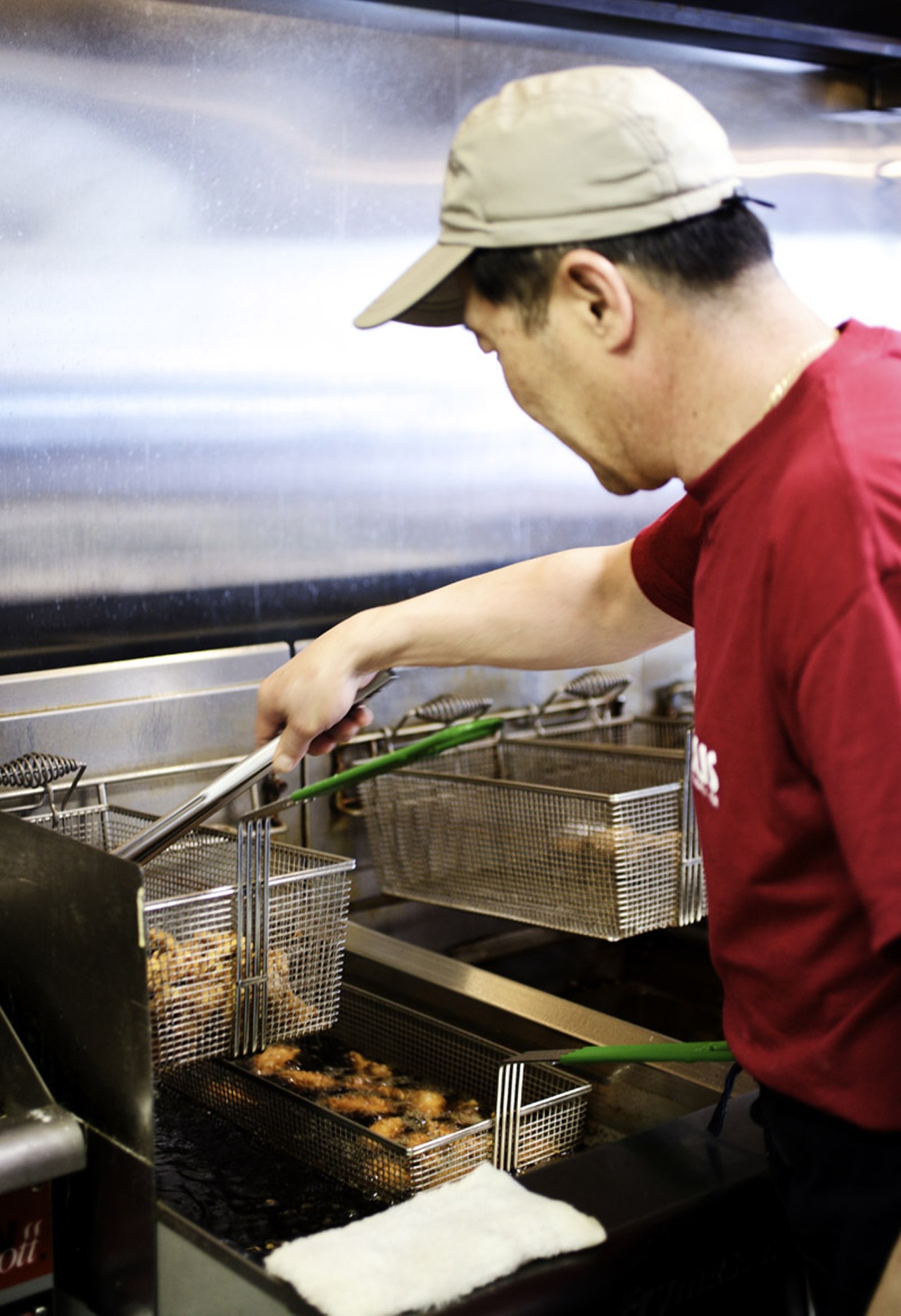 Owner Steve Song at work in the kitchen of O! Wing Plus in Overland, Missouri.