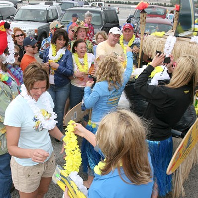 Landshark Lager representatives hand out leis and other promotional products to parrotheads.