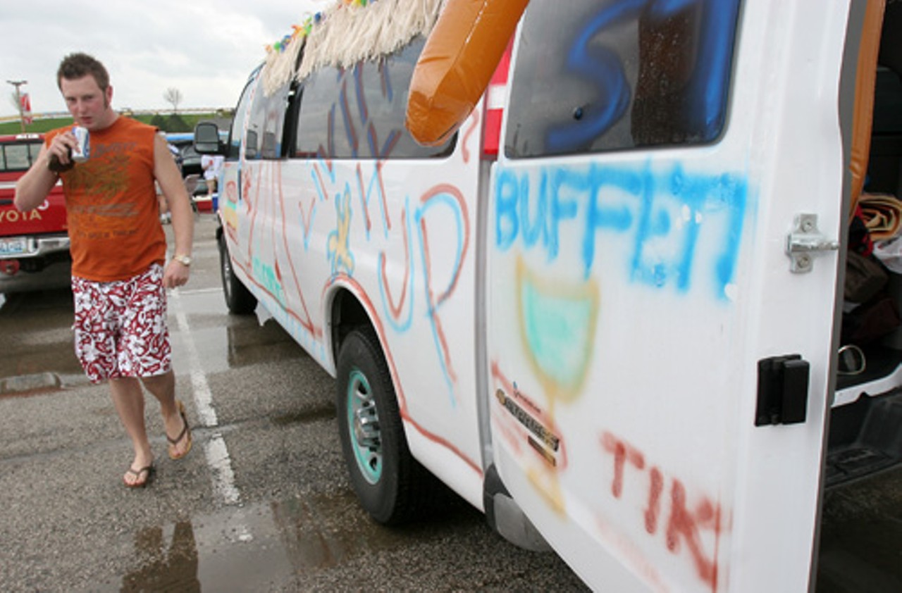 Jason Diemer walks around his painted rental van. He drove nine others from Springfield, Mo., and hopes he can pressure wash the paint off the van.