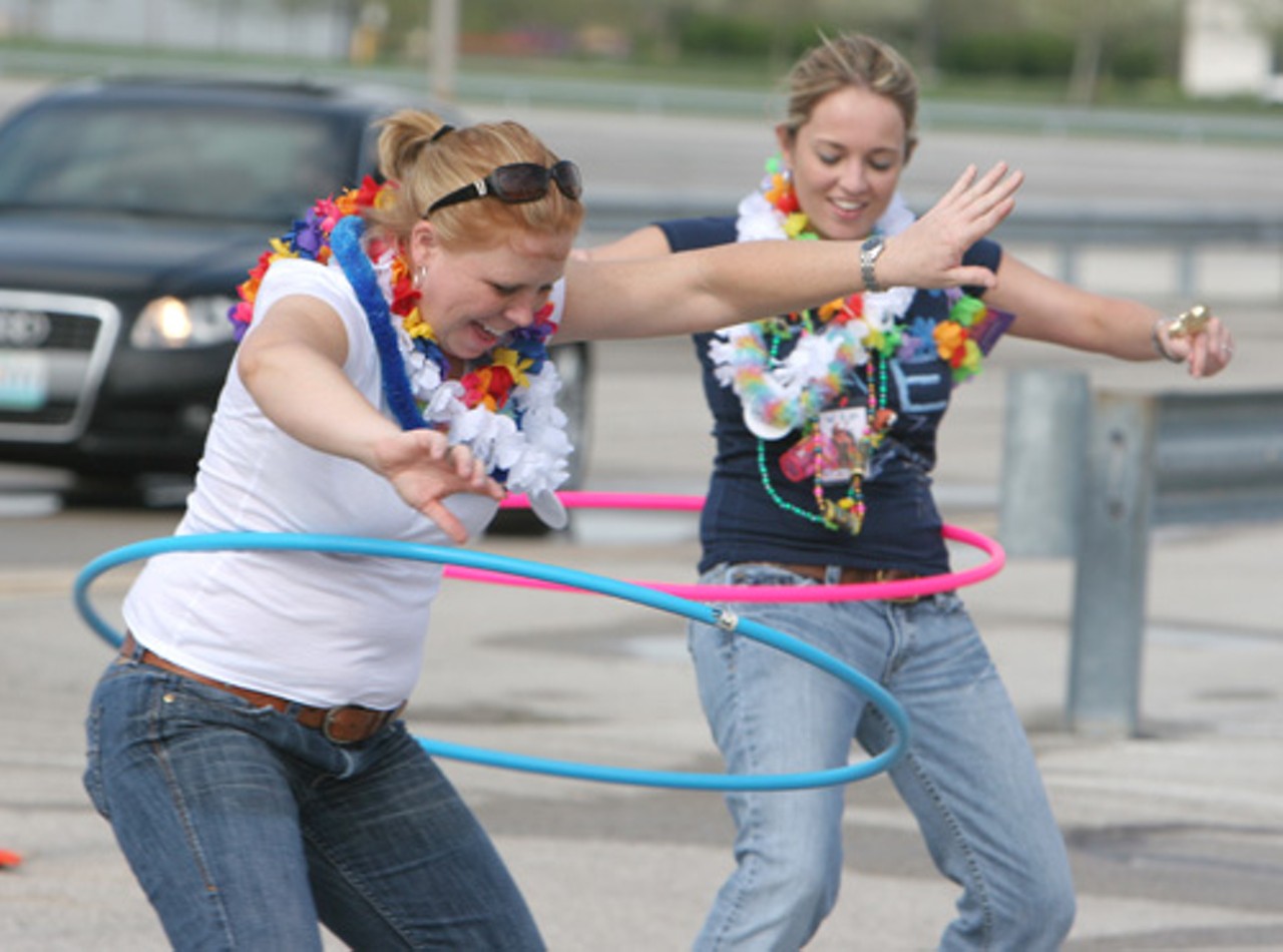 Summer Thompson, left, and Jennifer Douglas hula-hoop in the parking lot.