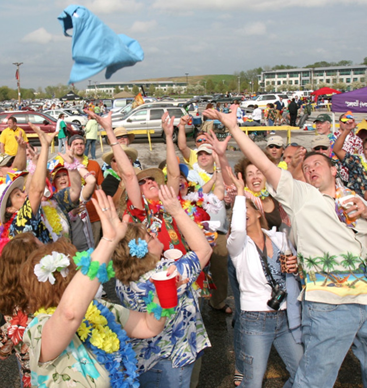 Margaritaville Express representatives toss T-shirts into the crowd.