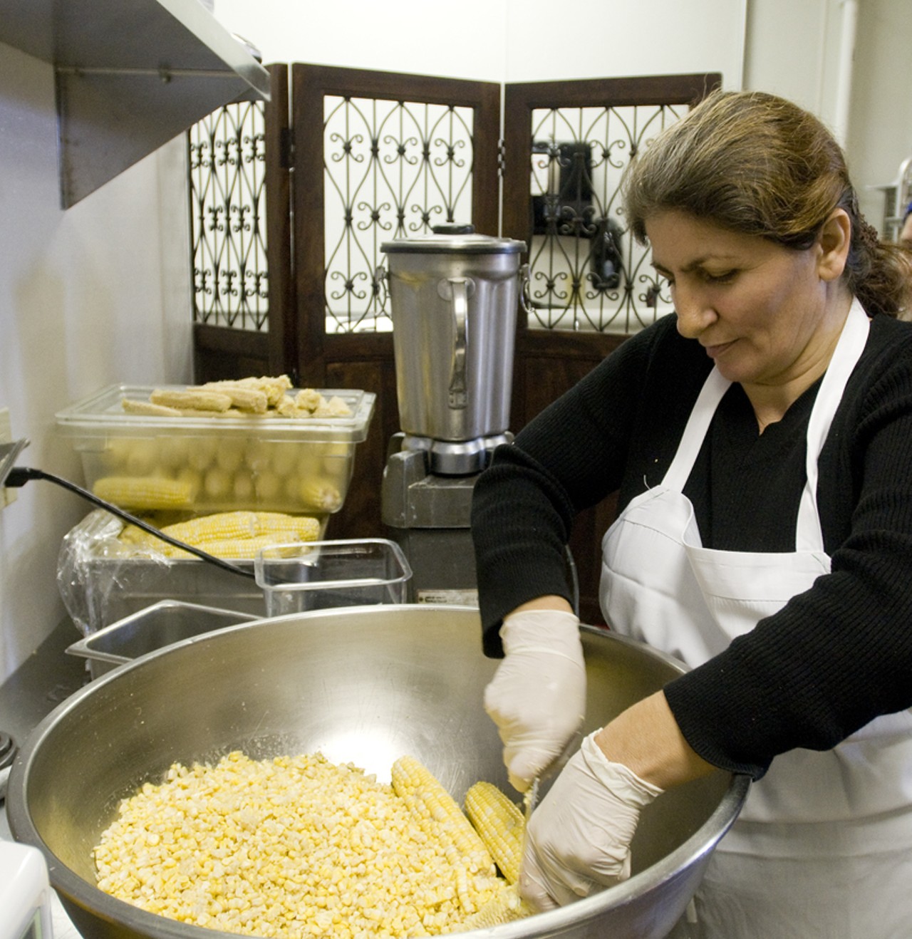 Nazira Shakhbazova has the task of cutting all the corn off the cobs.