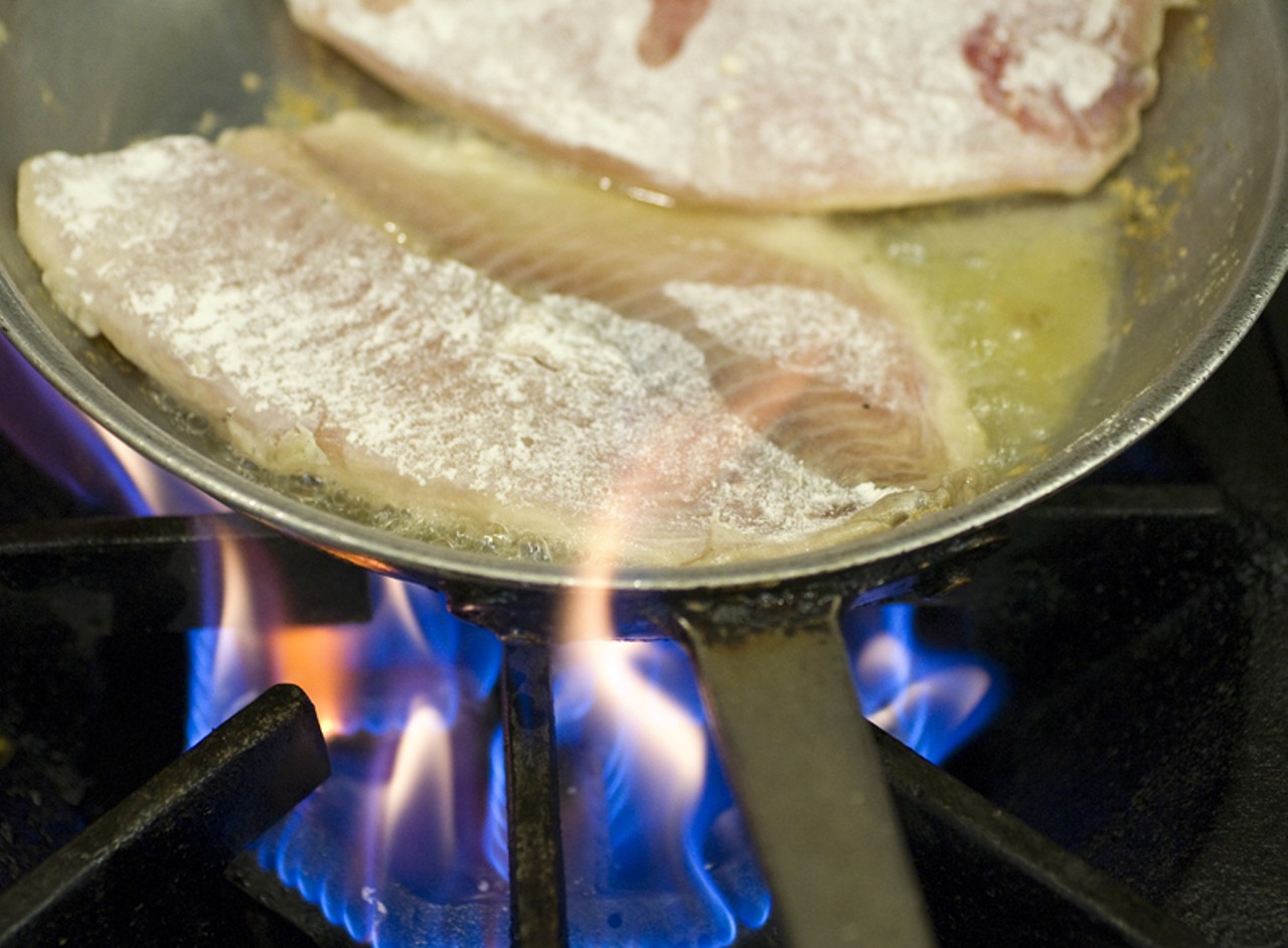 Cooking the pescado, or fish.