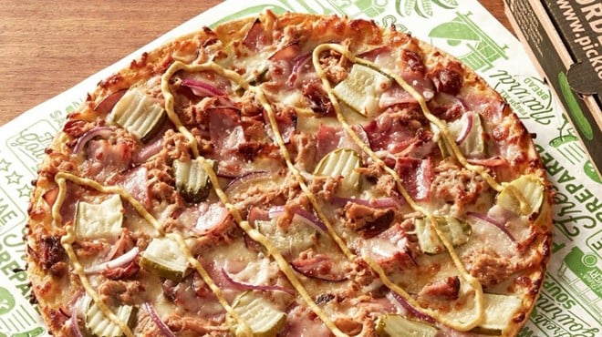 The Pickled Cuban pizza includes yellow-mustard sauce, smoked ham, pulled pork, cheese, bacon, onions, a spicy brown mustard drizzle and pickles.