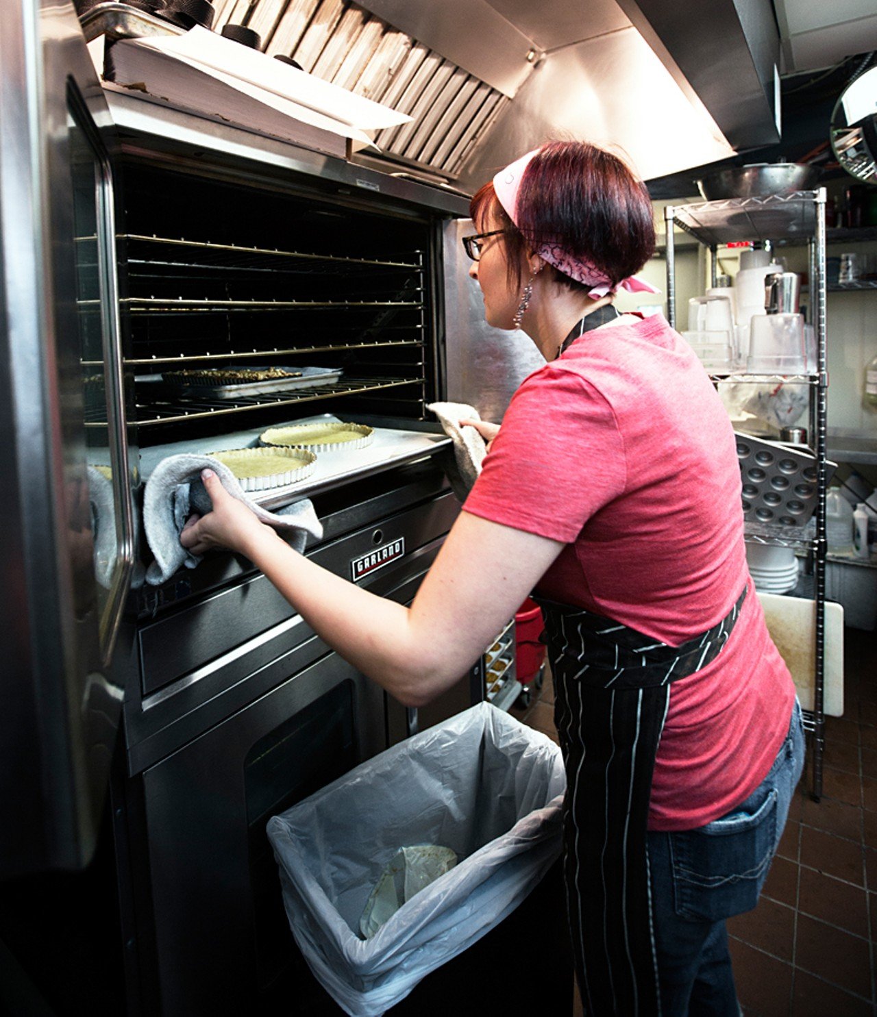 Owner Christy Augustin removes pie shells from the oven.