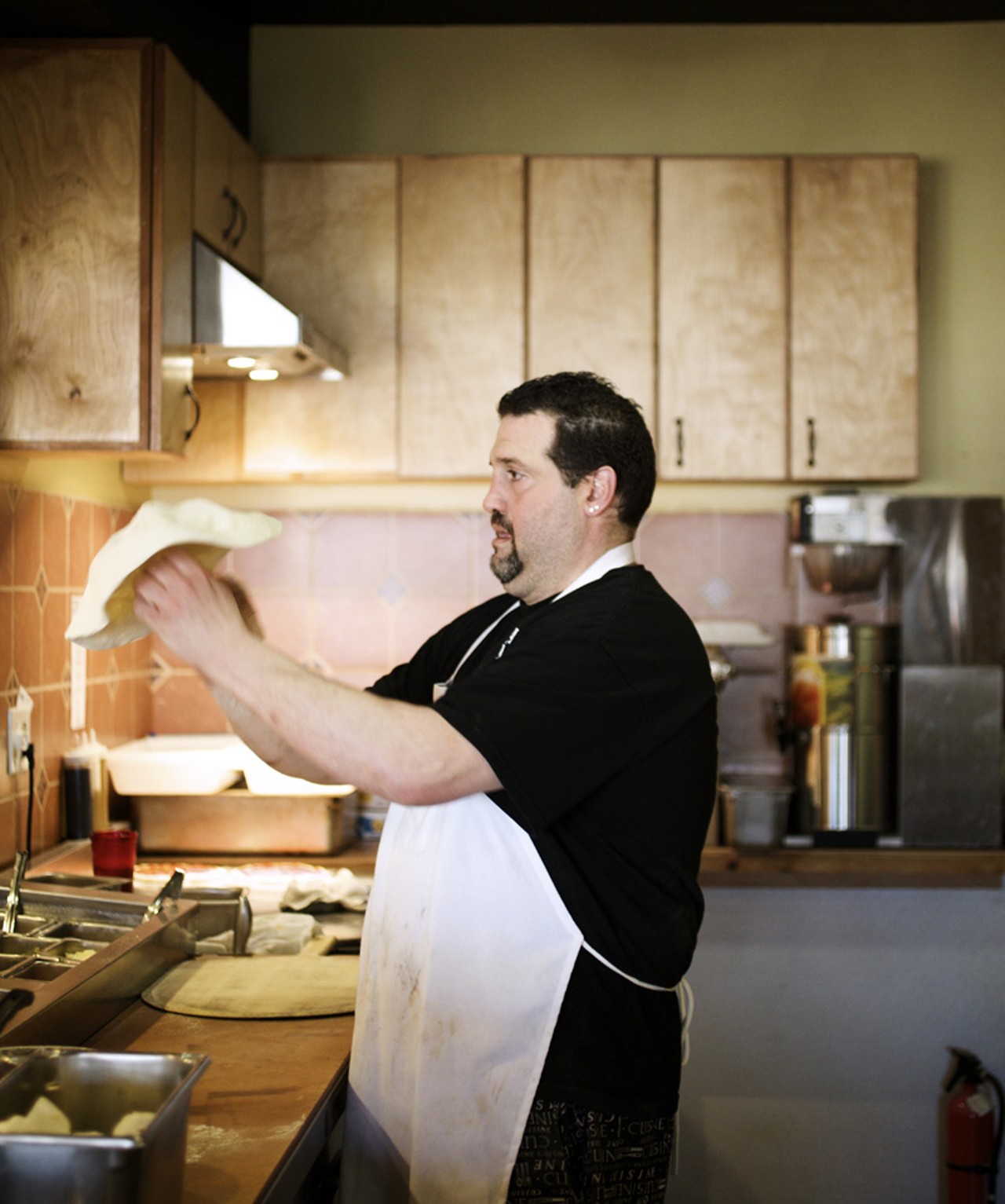 Sam Racanelli is the pizza man behind Pizzeria Tivoli. Sam, here, is stretching the pizza dough.