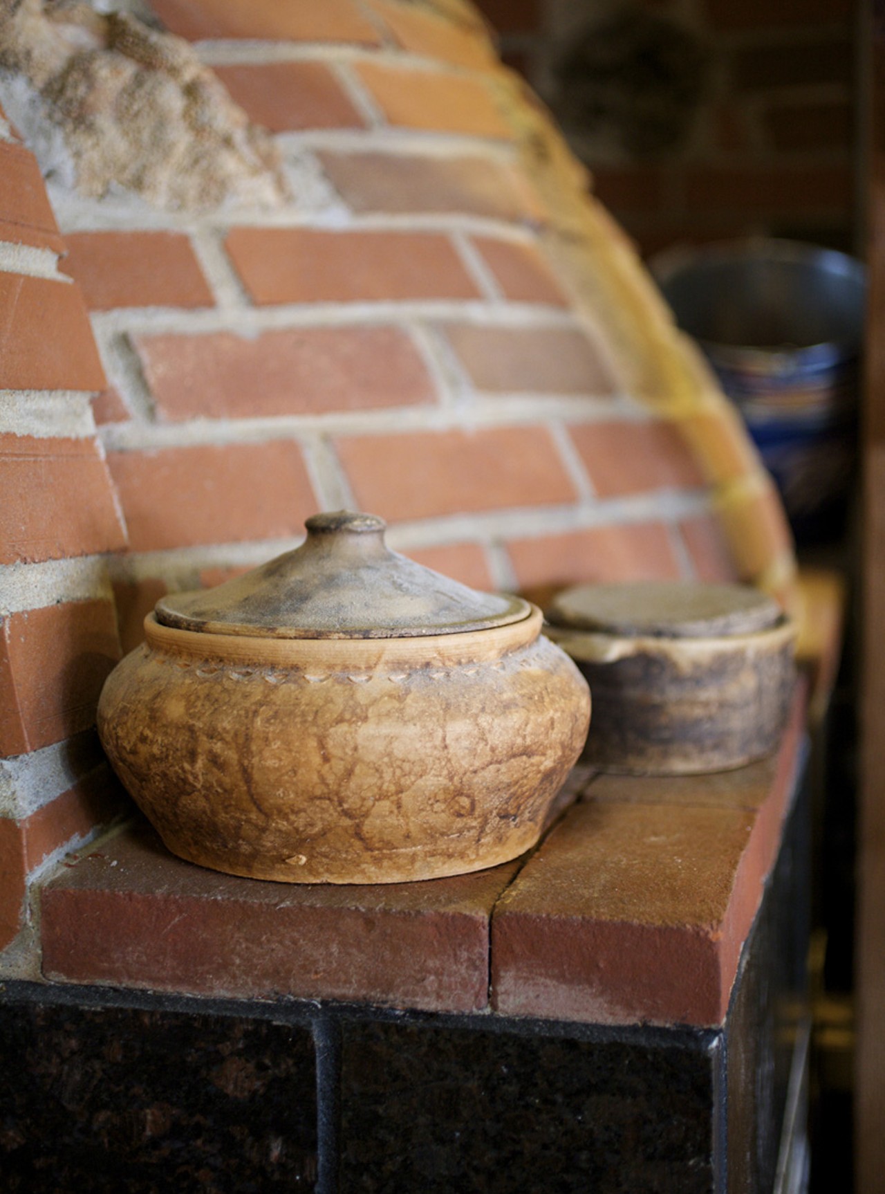 Clay pots adorn the wood burning pizza oven.