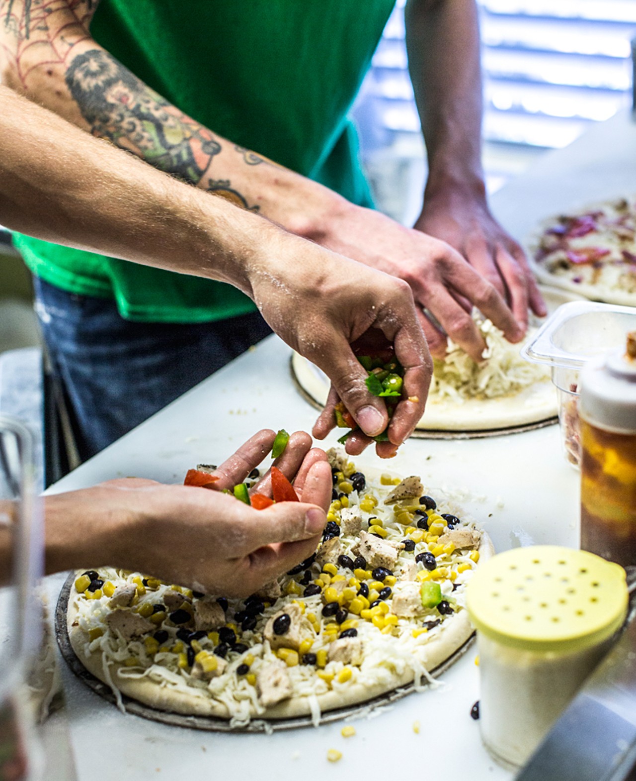 The "Lime Street" pizza is prepared using salsa chicken, roasted corn and black beans, mozzarella, fresh jalapenos, cilantro and a spicy sriracha drizzle.
