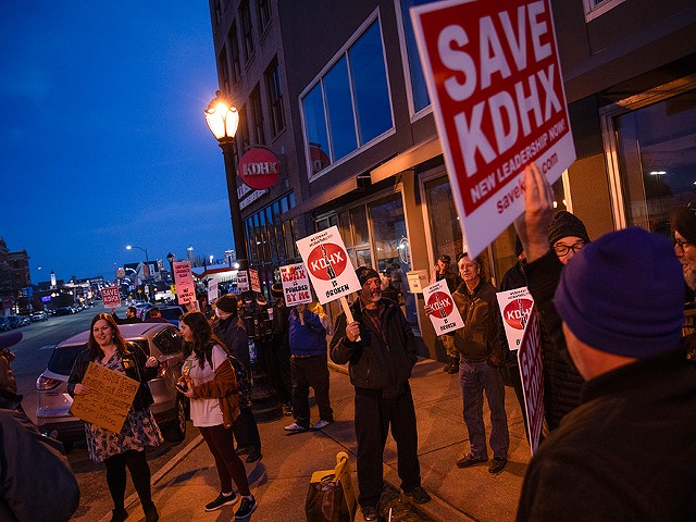 Demonstrators line the sidewalk in front of KDHX during a protest against the radio station’s leadership on Thursday, February 29, 2024.