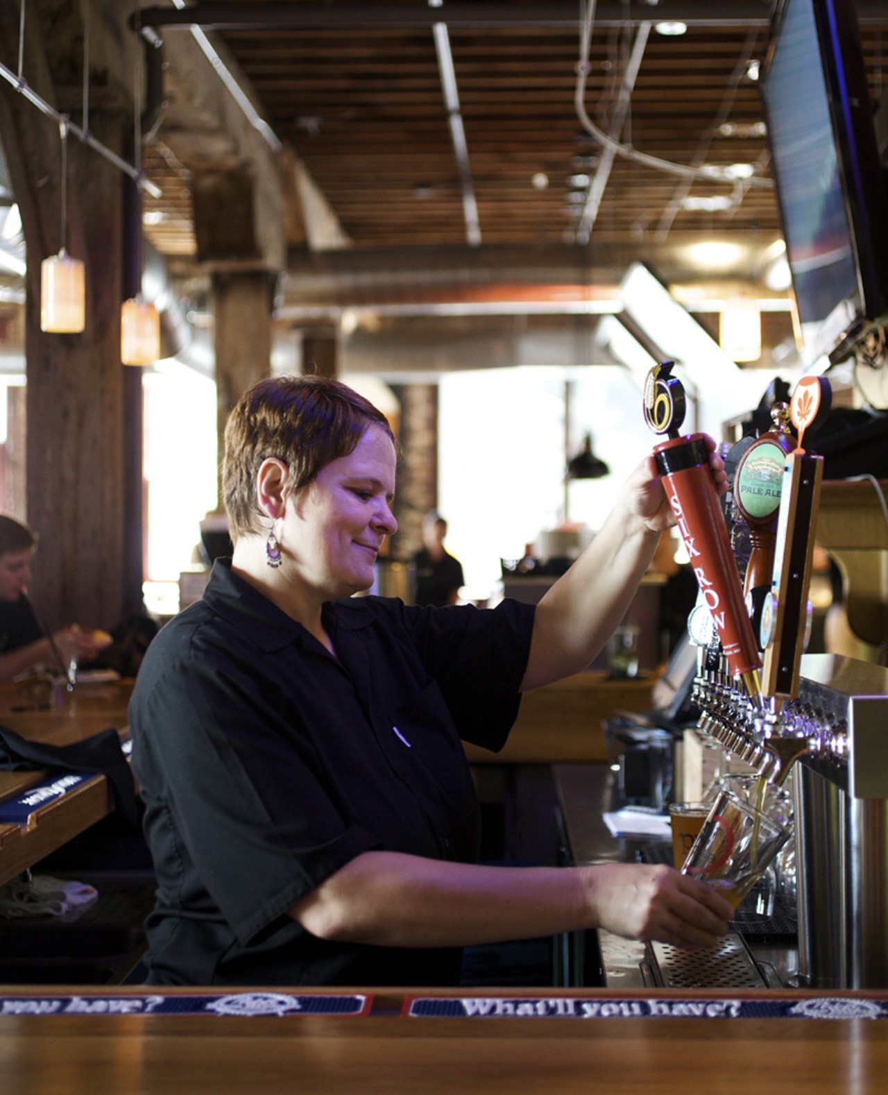 Bartender Renee Ludwig pours a pint from local Six Row Brewing.