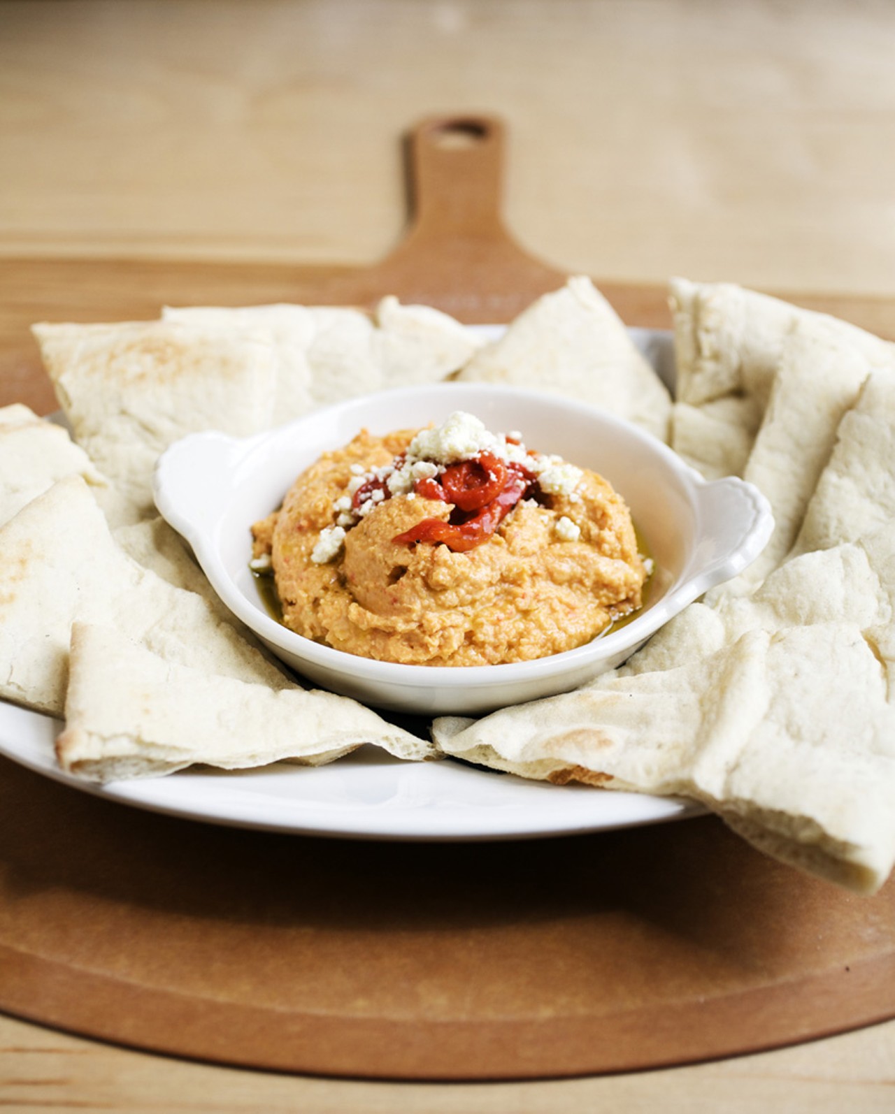 Roasted Red Pepper Hummus appetizer is served with warm pita or fresh vegetables (not shown.)