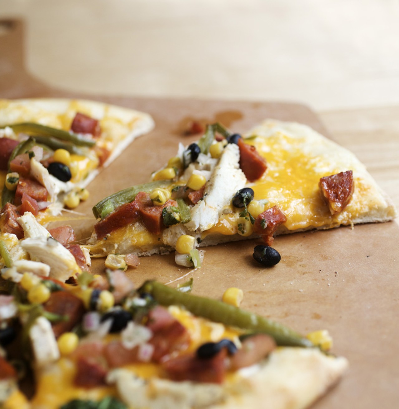 The South of the Border pizza is prepared with cr&egrave;me fraiche, chicken, chorizo, roasted jalapeno, corn-black bean-tomato-cilantro salsa and monterey jack. All pizzas can be prepared with either the PW Original, Honey Wheat or Gluten Free crusts.