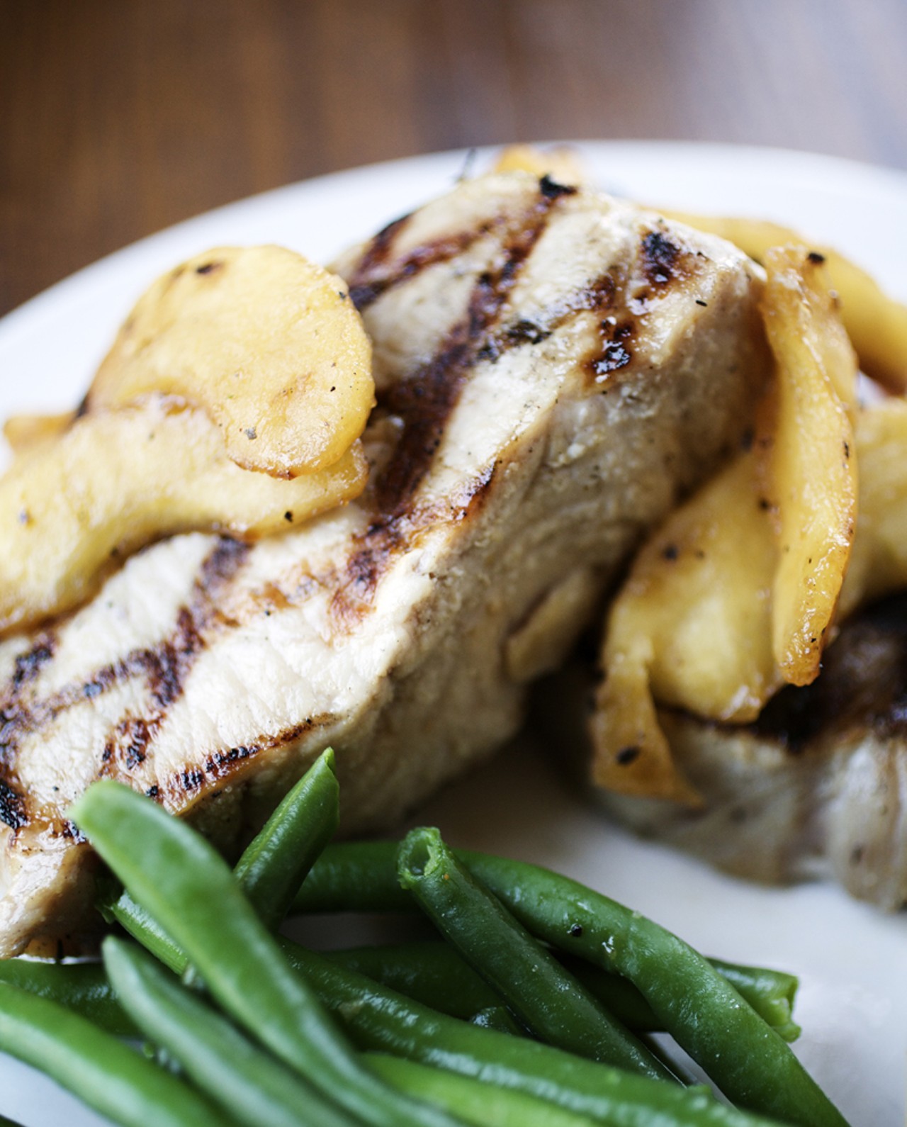 The Bistro Pork Chops are two 6oz center cut boneless chops seasoned and grilled and finished with saut&eacute;ed Fuji Apples in a cinnamon amaretto glaze.