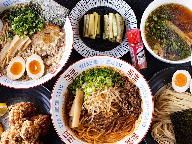 A selection of items from Menya Rui, including (clockwise from top left) pork shoyu ramen, house cucumbers, original tsukemen, tantanmen brothless and karage.