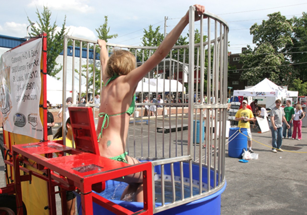 Cathleen Joffray attempts to hang on while she&rsquo;s getting dumped in the dunking booth.