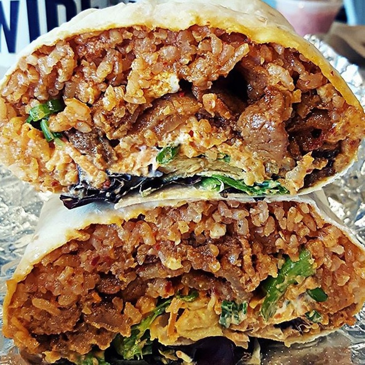 Burritos - Seoul Taco
St. Louis&#146; David Choi didn&#146;t invent Korean-Mexican fusion, but he sure has perfected it. Since opening his Seoul Taco food truck in 2011, the restaurateur has grown his brand, first as a small brick-and-mortar location and now as a burgeoning regional chain with locations from Columbia to Chicago. If you wonder how he&#146;s become so successful in such a short time, head to his Delmar Loop storefront and order one of his gigantic burritos stuffed with bulgogi steak. The juicy beef, marinated in a mouthwatering cocktail of soy, sesame oil, sugar, garlic and ginger, is paired with kimchi fried rice and accouterments then wrapped in a tortilla. The marinade and kimchi jus combine with sour cream to create a glorious burst of flavor that can no more be contained in a wrap than Choi&#146;s business can be contained in a tiny truck. Photo courtesy of Instagram / foodandtraveljunkie via pikore.com.
