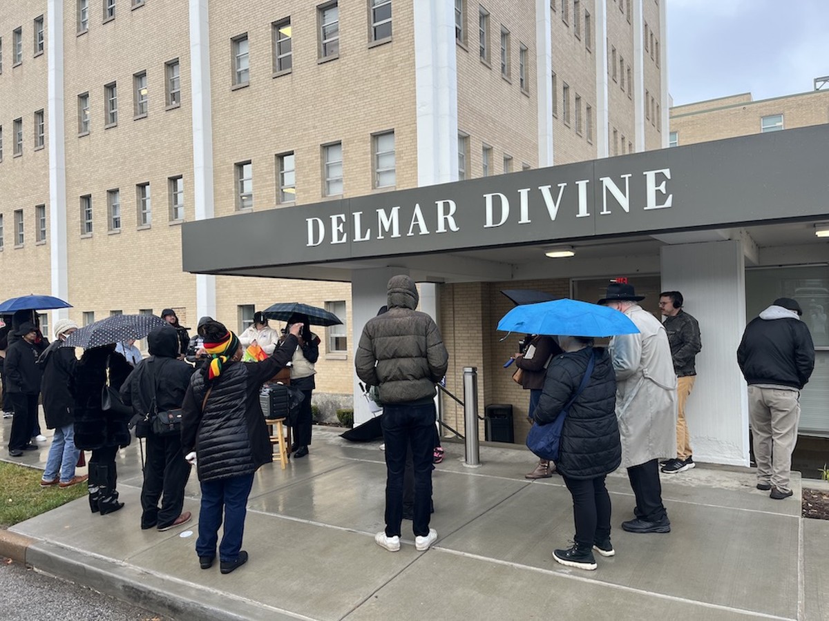 Protestors gather around the Delmar Divine in opposition to the Opportunity Trust, which has worked to expand charter schools in St. Louis.