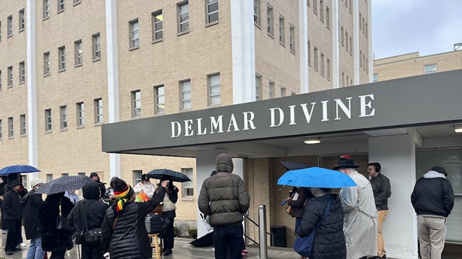 Protestors gather around the Delmar Divine in opposition to the Opportunity Trust, which has worked to expand charter schools in St. Louis.