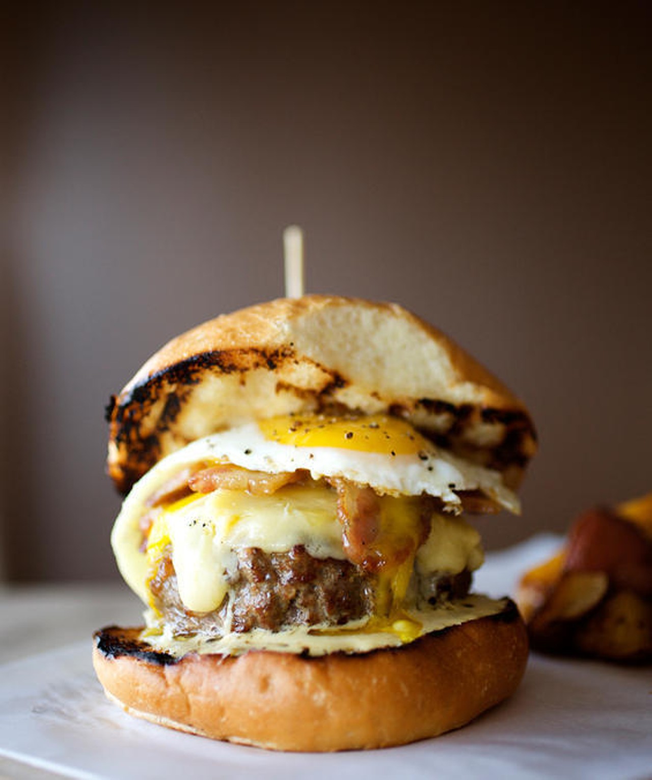 A mainstay on the lunch menu, the Cheeseburger, is Missouri grass fed beef, roasted garlic aioli, bacon, Iowa sharp cheddar and a fried egg served with roasted red potatoes.