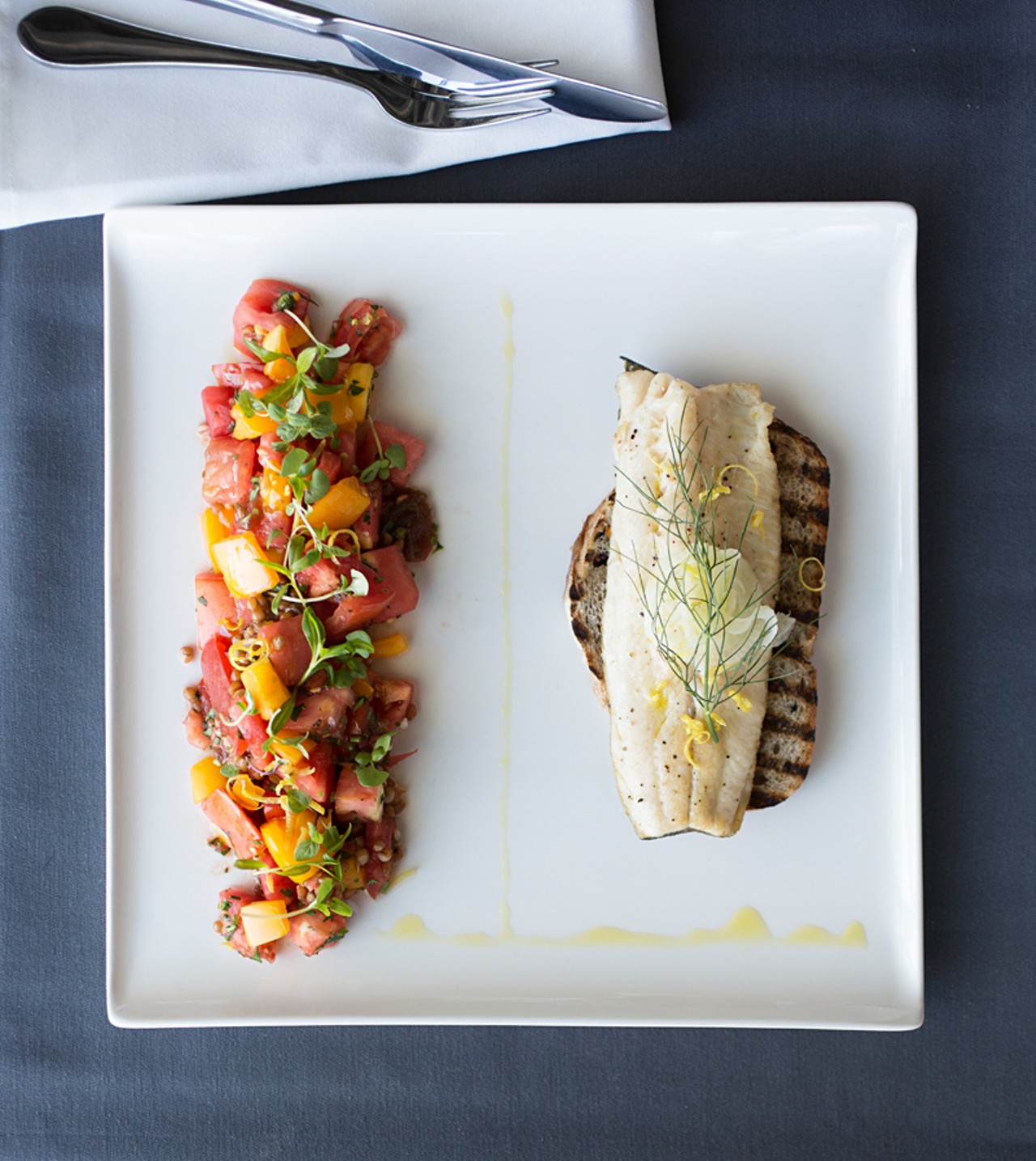 The roasted-trout filet sandwich is made with fresh herbs and summer tomato between Companion olive bread. Served with a wheat-berry salad and red-wine vinaigrette.