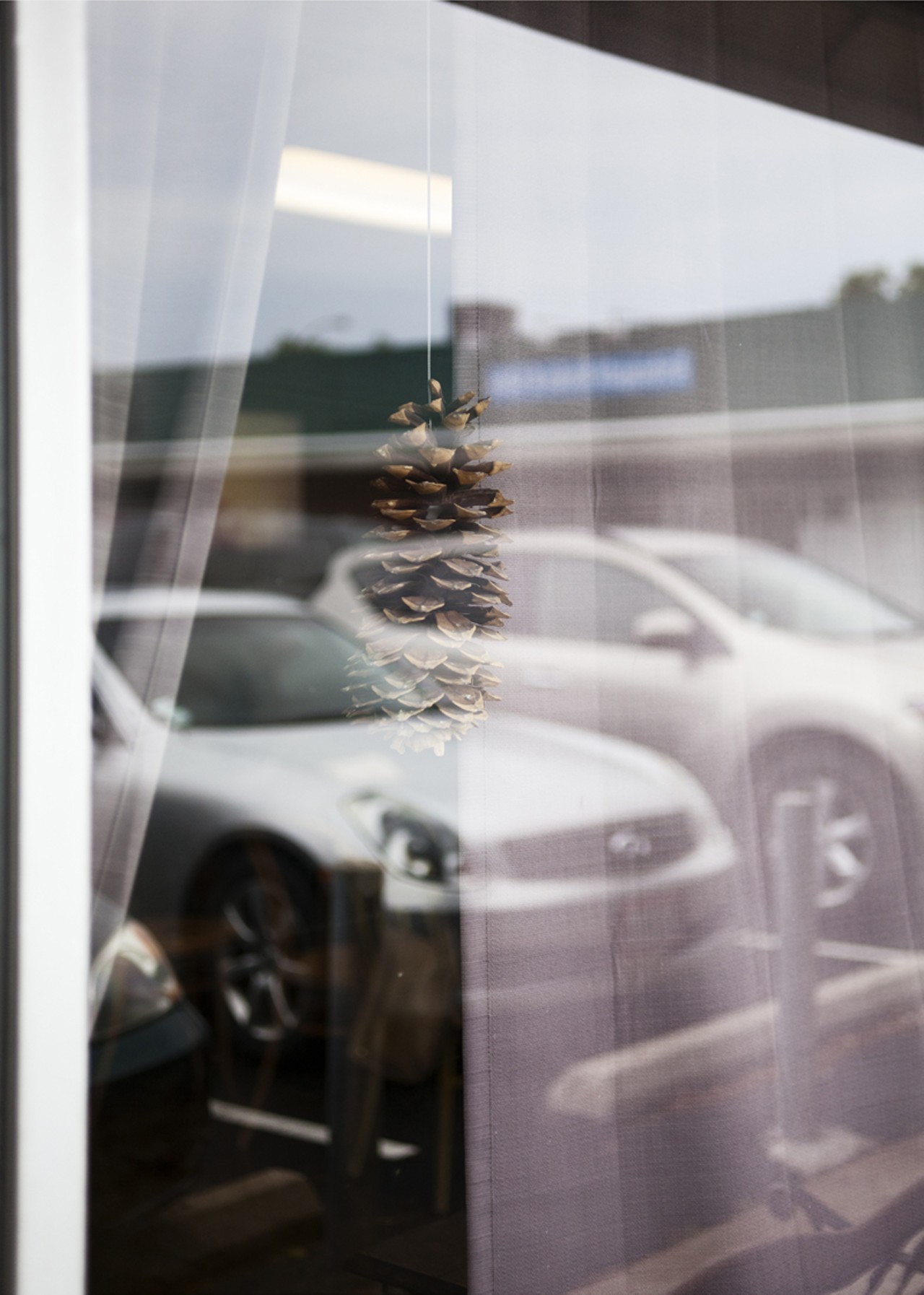 A single pine cone hangs in each window at Salume Beddu.