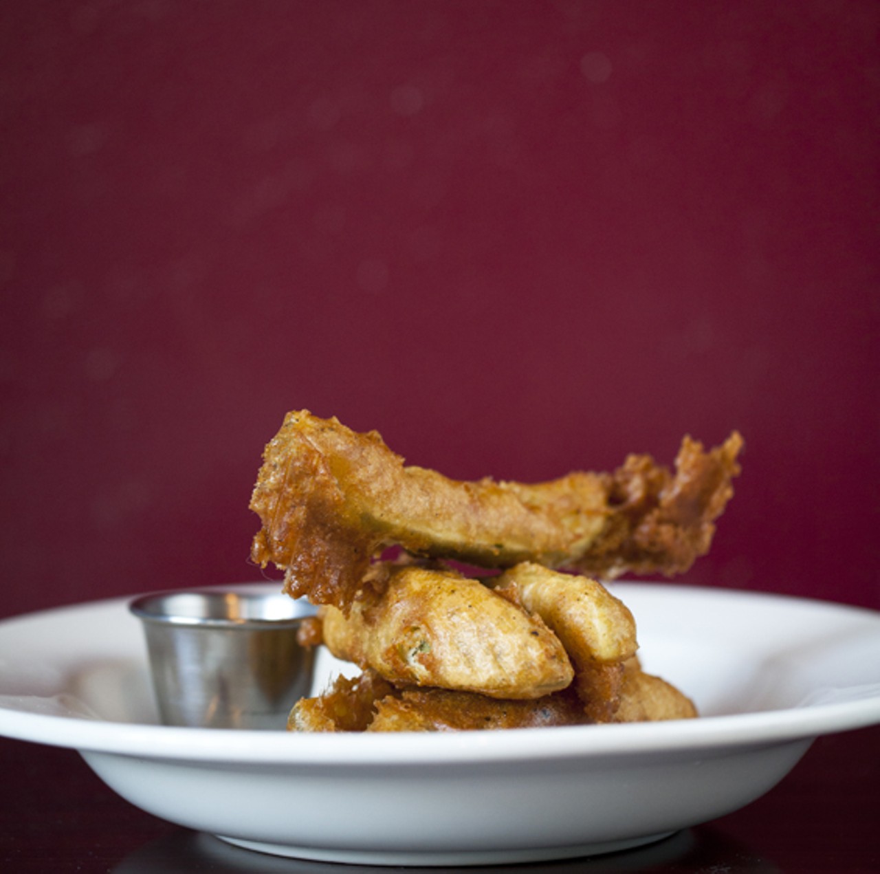 An appetizer of Fried Pickles with the housemade jalapeno watermelon BBQ sauce.