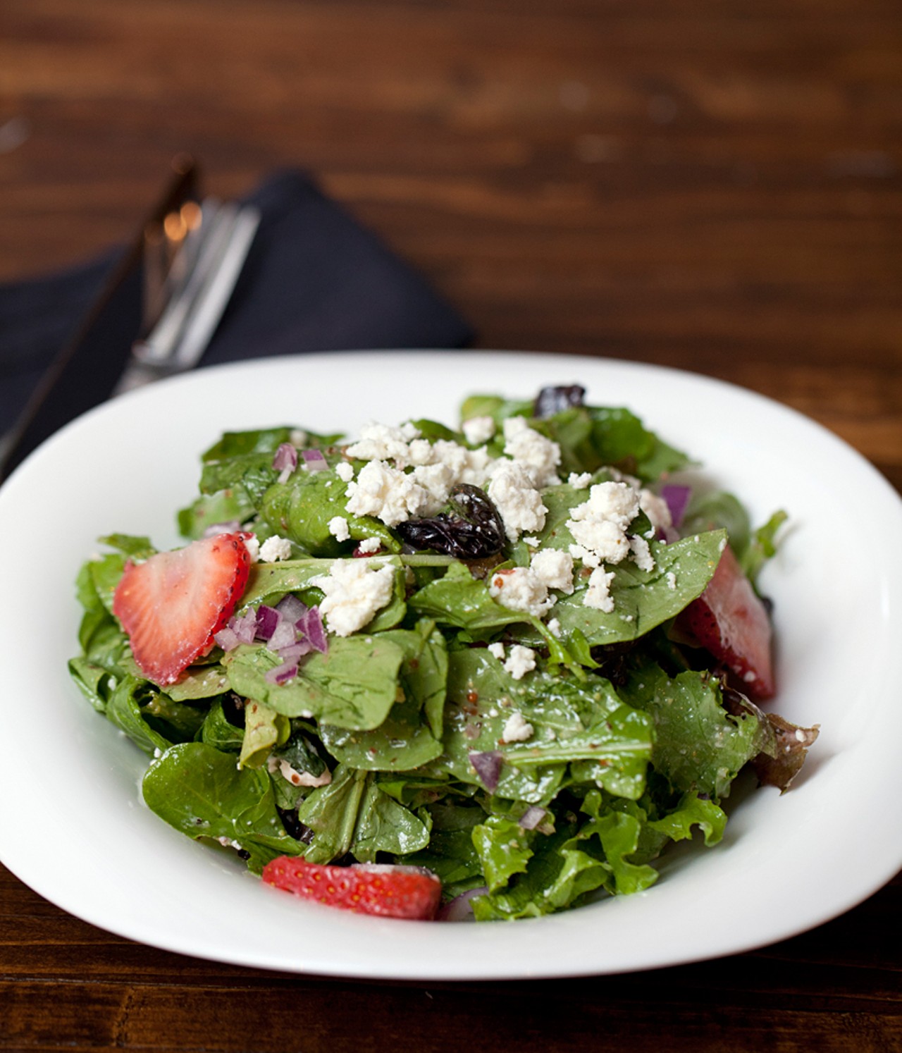 The "Strawberry Fields" salad is spring mix, strawberries, feta, red onion, sage, mint and candied walnuts with a white balsamic vinaigrette dressing.