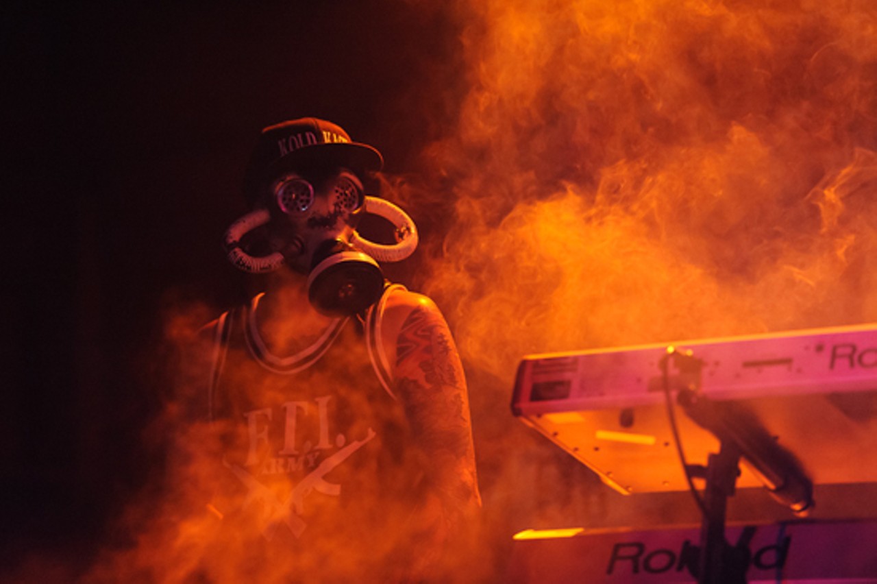 Kold Kase, opening for Snoop Dogg, brought along a hype man in a gas mask.